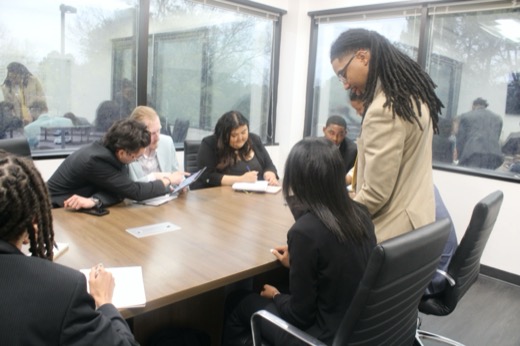 Three Contrast Marketing team members collaborating and reviewing notes at a conference table