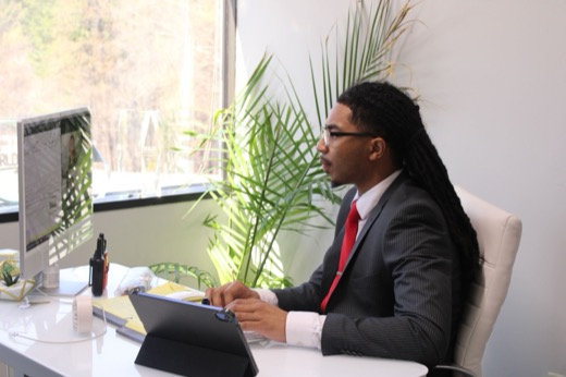 Hamilton leading a training session at the whiteboard with team members